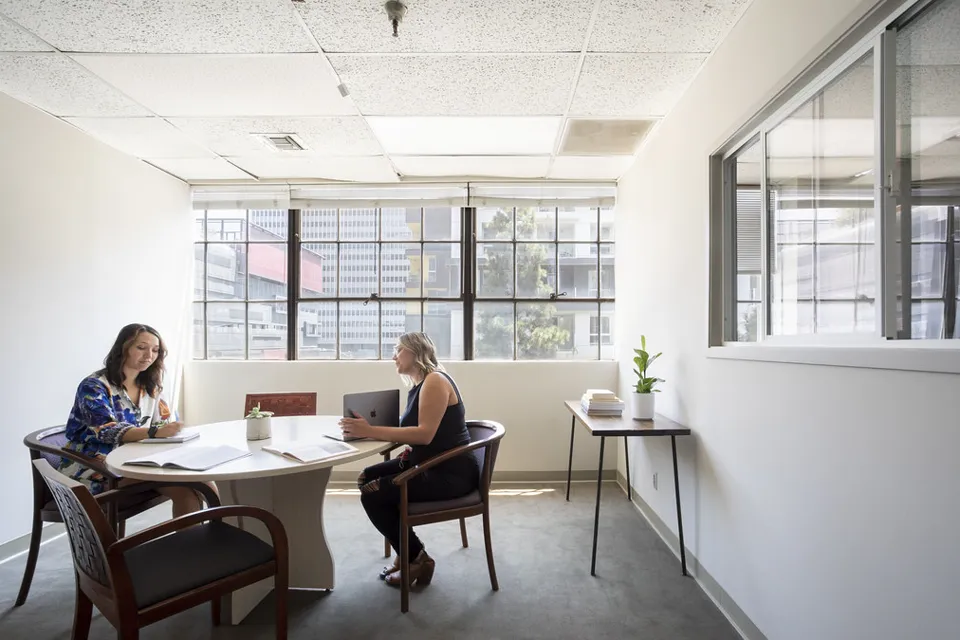 Small meeting room with a table and chairs